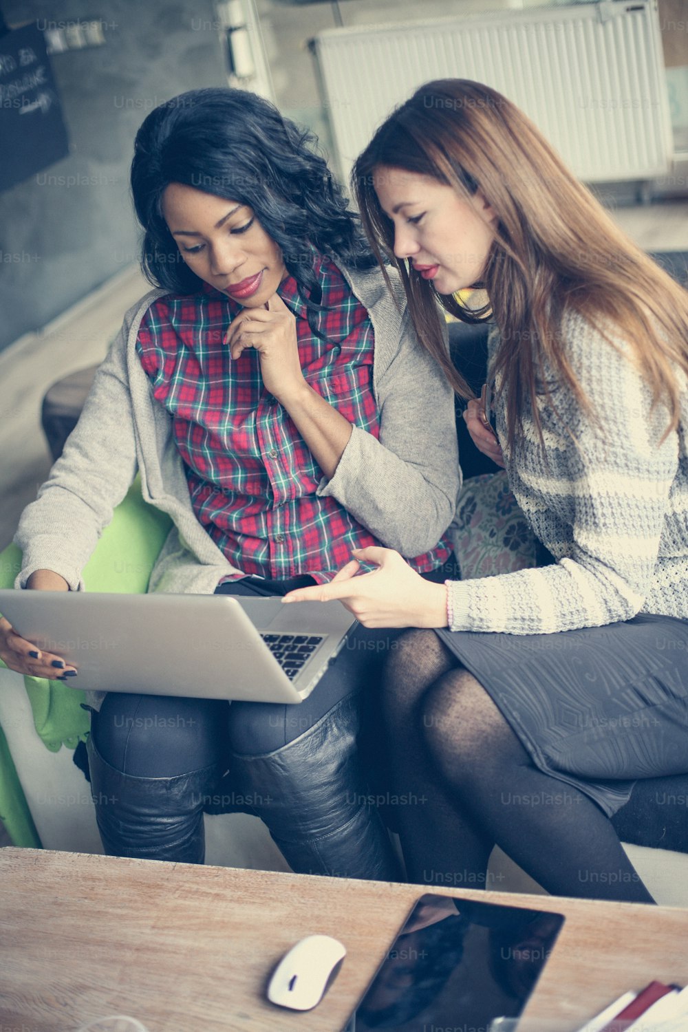 Young business women working on a laptop.