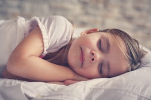 Little girl sleeping in bed.