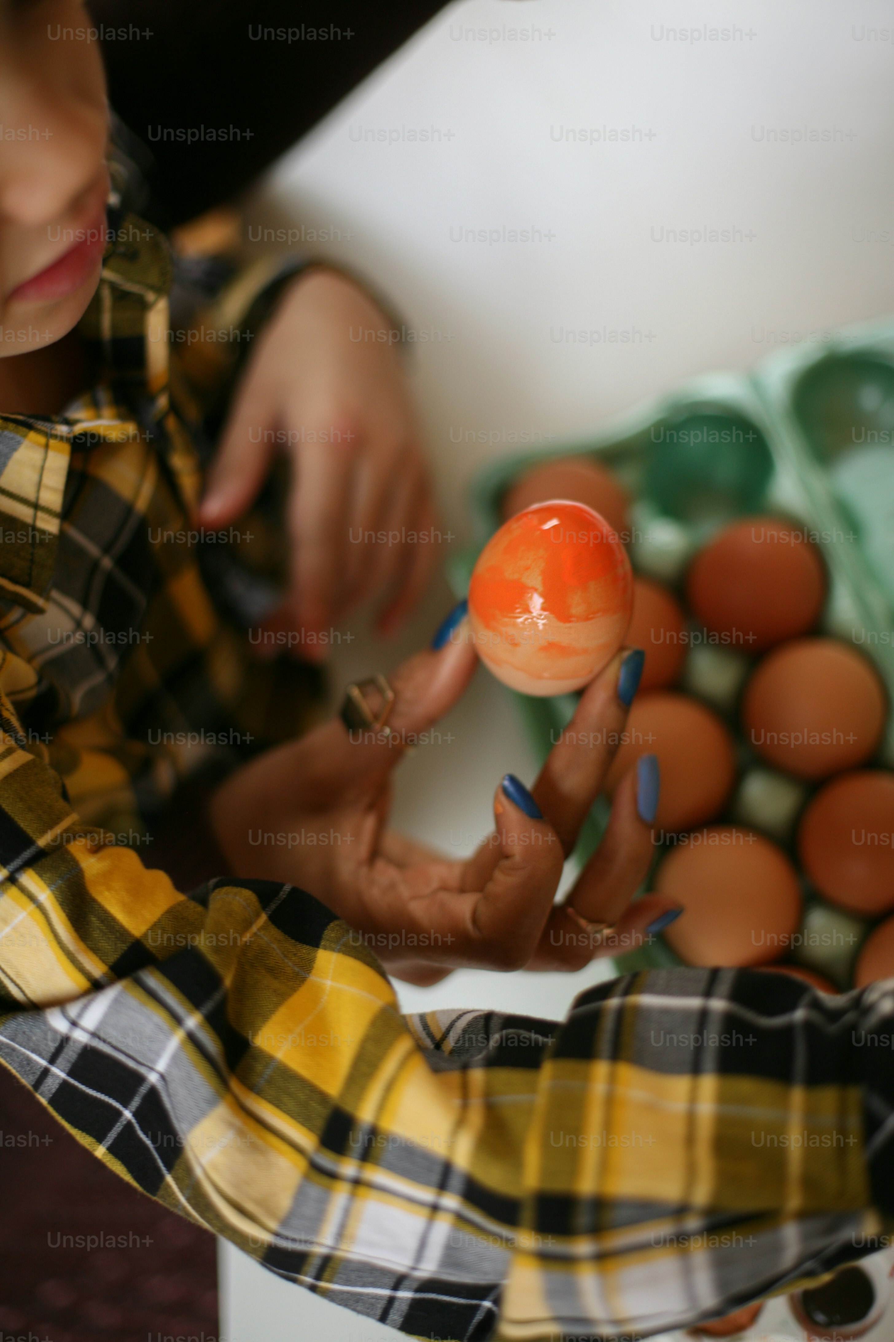 African American woman with her son prepare for Easter . Close up. From above.