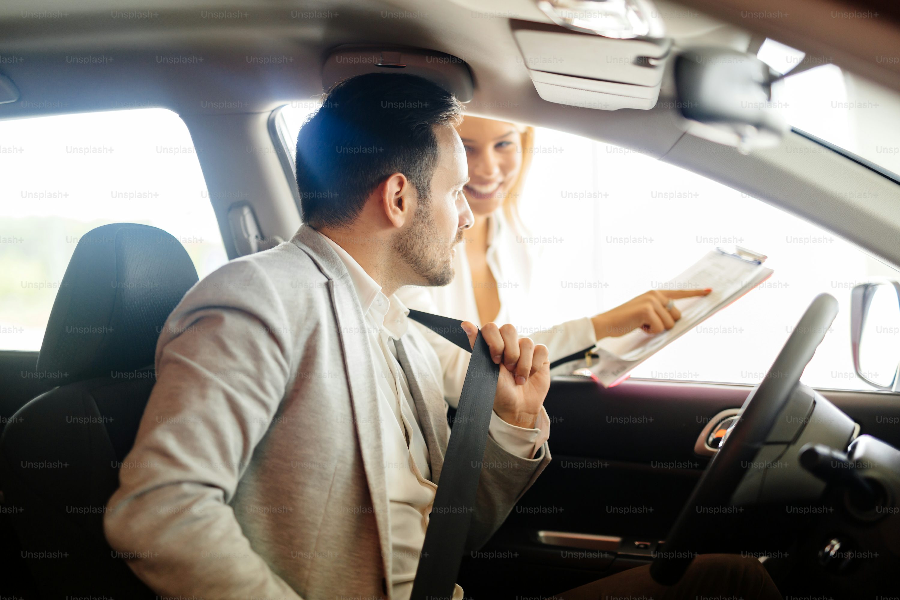 Salesperson selling cars at car dealership