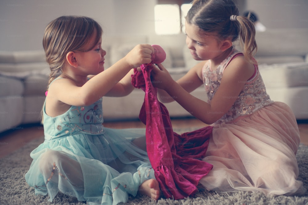 Look, this is my new beautiful dress. Cute little girl showing het new dress to her friends.