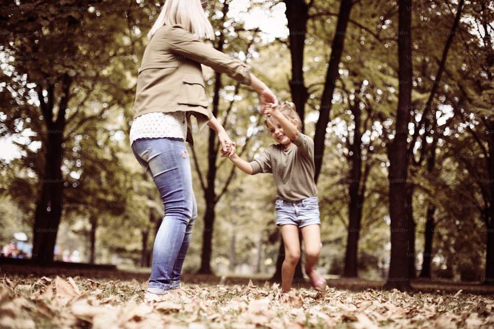 Mother and daughter having fun in the park.