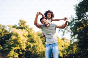 Happy father and child spending time outdoors and laughing