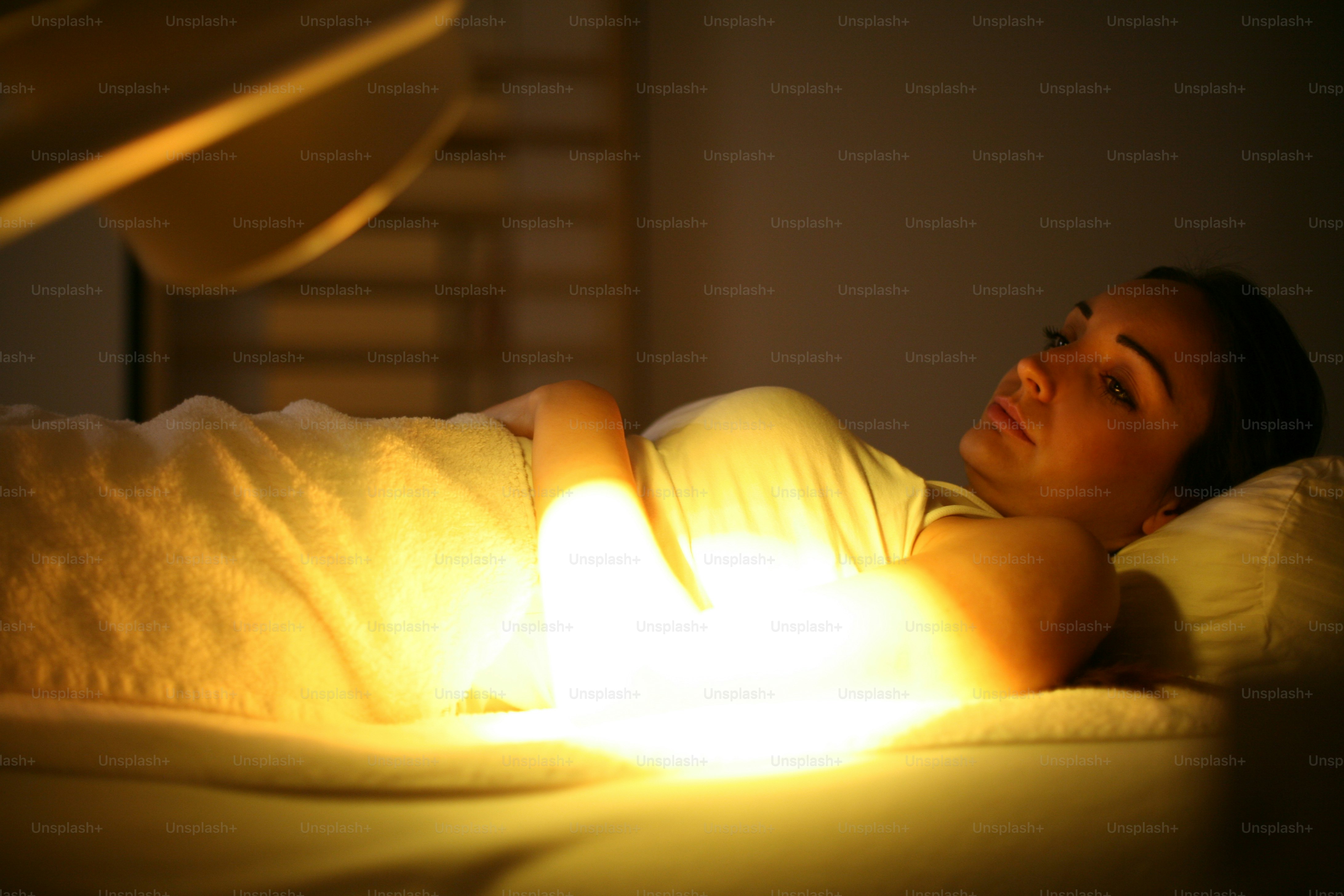 Person standing near infrared light therapy panels during recovery session