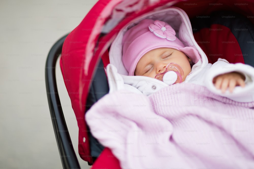 Baby sleeping in pram outdoors