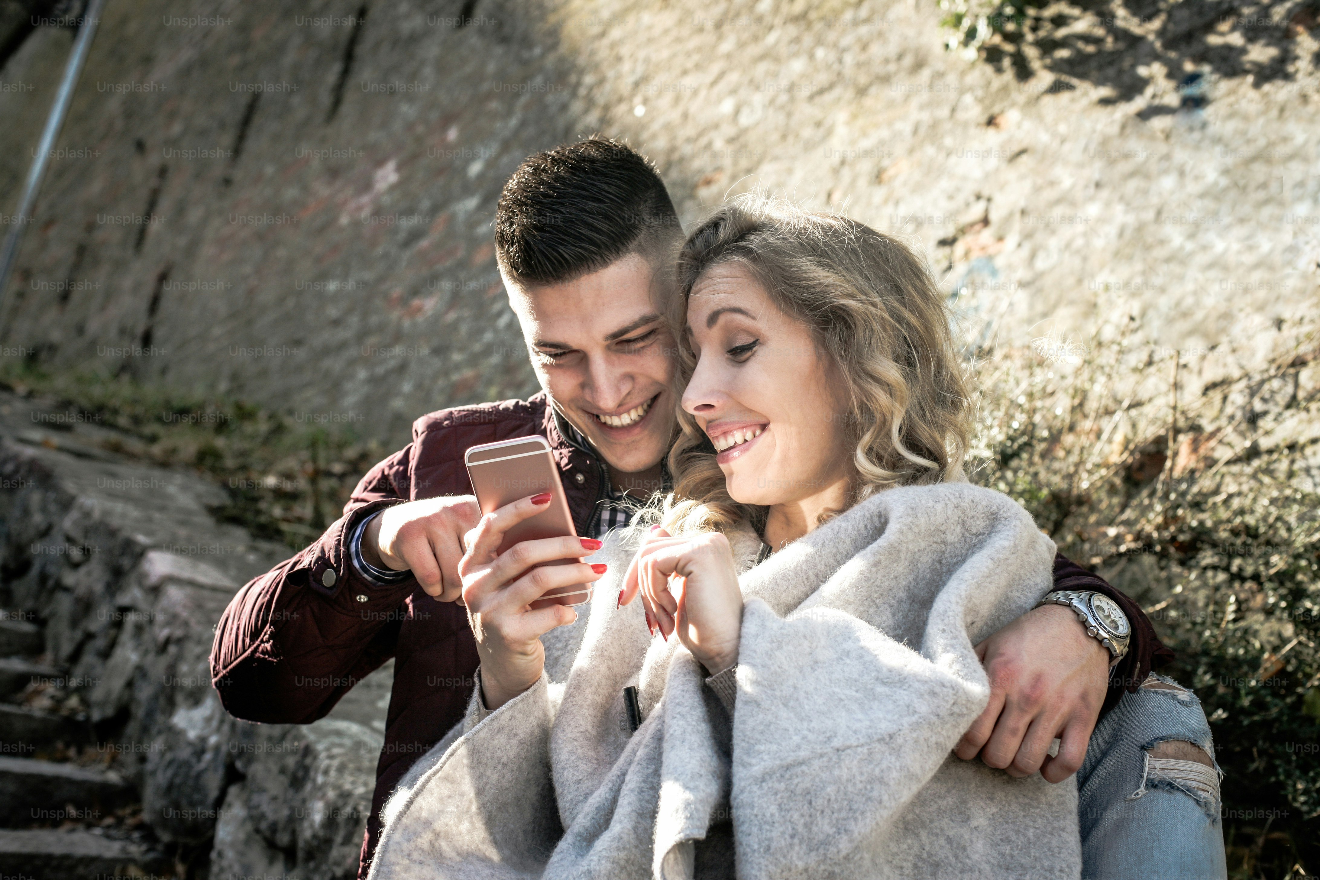 Young couple using smart phone.