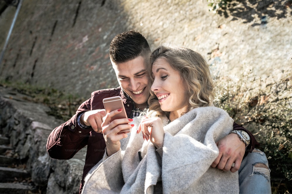Young couple using smart phone.