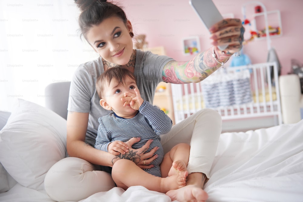 Young mother taking self portrait with smartphone