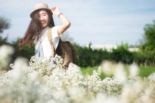 Young Woman Traveler with backpack relaxing outdoor. Summer vacations and Lifestyle Travel Outdoor Concept.