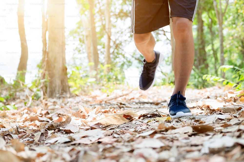 Trail running man exercising outdoors for fitness. Healthy Fitness Park and Outdoor concept.