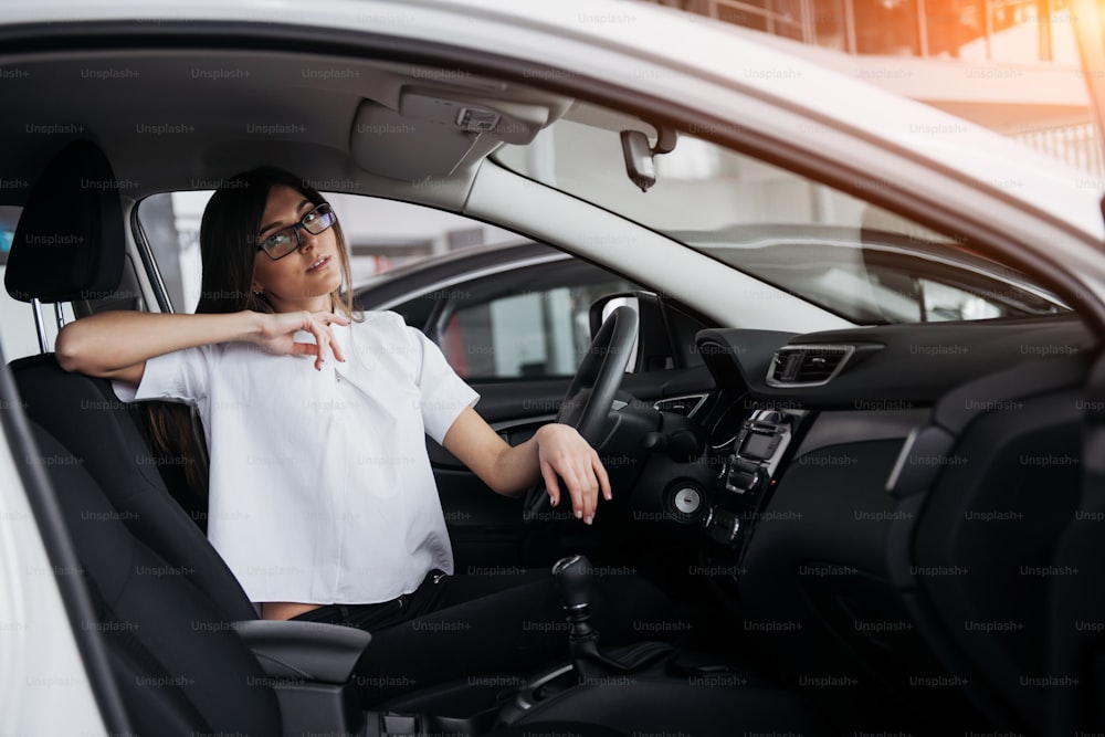 portrait of young beautiful woman sitting in the car.