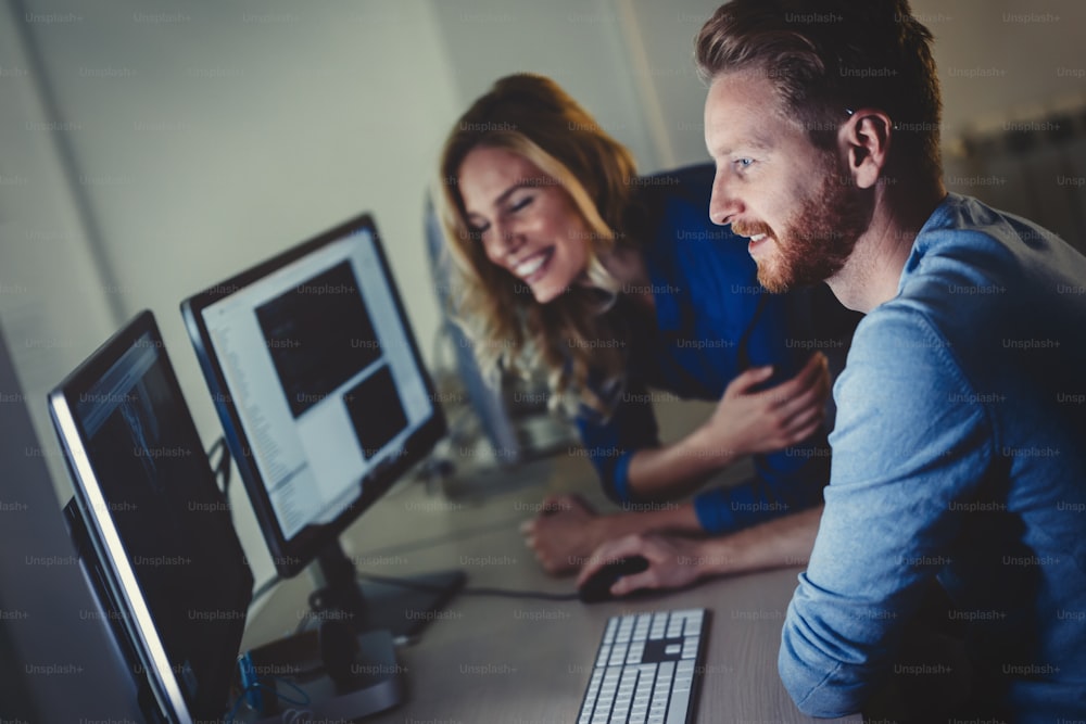 Programmers and business people collaborating in company office