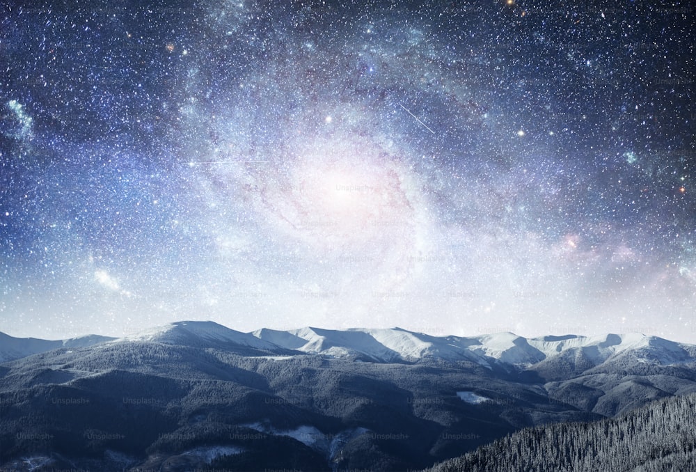 fantastic winter meteor shower and the snow-capped mountains. Dramatic and picturesque scene. Courtesy of NASA. Carpathian, Ukraine, Europe.