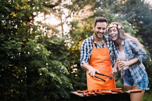 Young beautiful woman and handsome man having barbecue