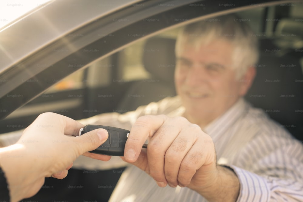 Focus is on hand with car key.