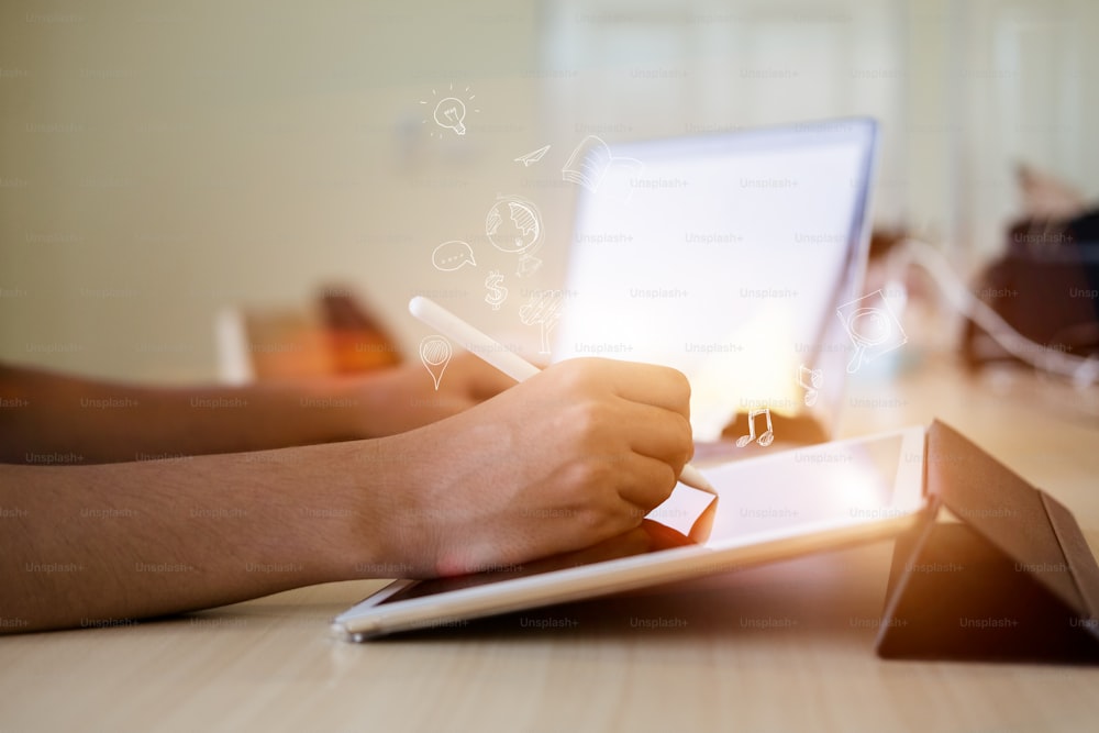 Man working with stylus on digital tablet pc. Graphic tablet, pen and keyboard.