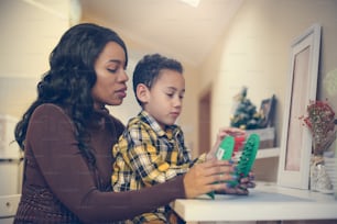 Mother with her son. Mother teaching her son to accounting.