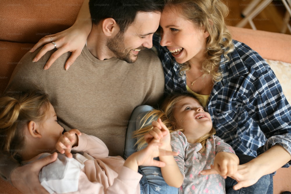 Happy family at home spending time together. From above.