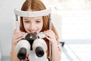 A few minutes procedure. Obedient smart bright girl following doctors instructions and trying not blinking while he examining her eyes