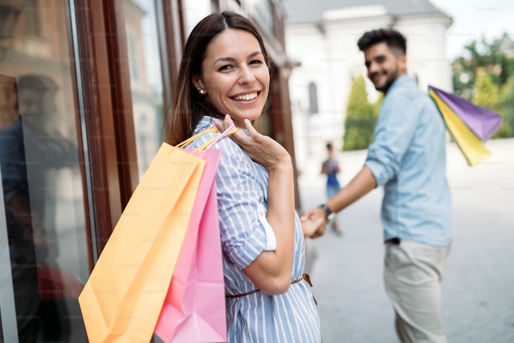 Happy attractive loving couple enjoy spending time in shopping together