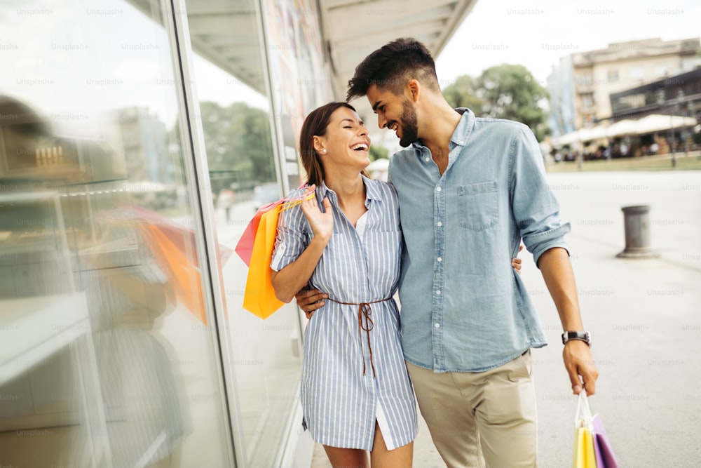 Happy attractive loving couple enjoy spending time in shopping together