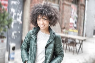 Happy young african american woman smiling, looking at camera.