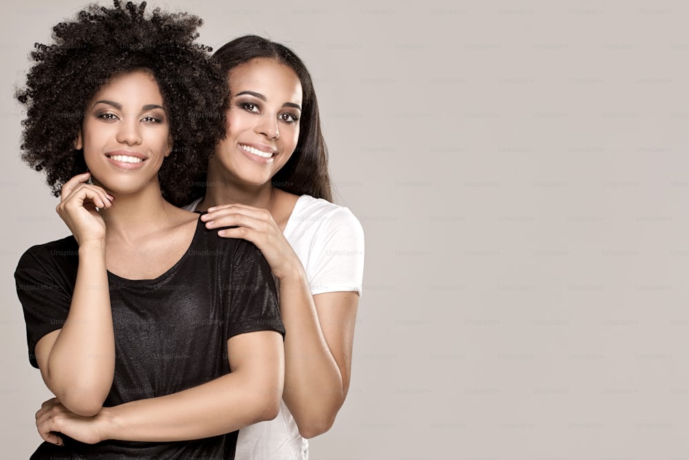 Beauty photo of two natural young african american girls. One girl with afro hairstyle.