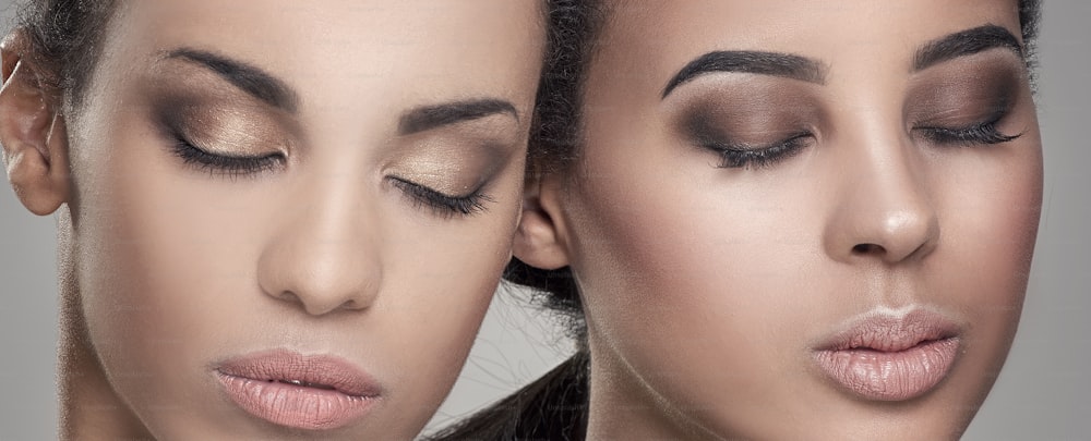 Two beauty young african american women. Closeup portrait of beautiful girls with natural makeup.