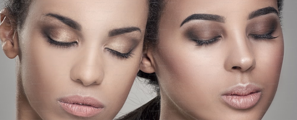 Duas mulheres afro-americanas jovens beleza. Retrato em close-up de meninas bonitas com maquiagem natural.