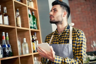 Bartender doing an inventory of the products