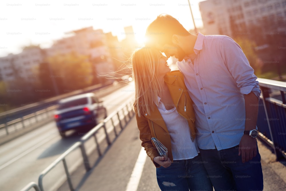 Happy tourist couple in love with map traveling outdoors