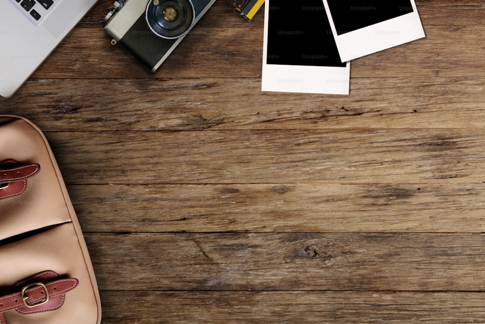 Hipster freelance photographic equipment on a wooden desktop with laptop.