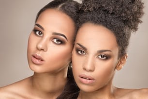 Two beauty young african american women. Closeup portrait of beautiful girls with natural makeup.