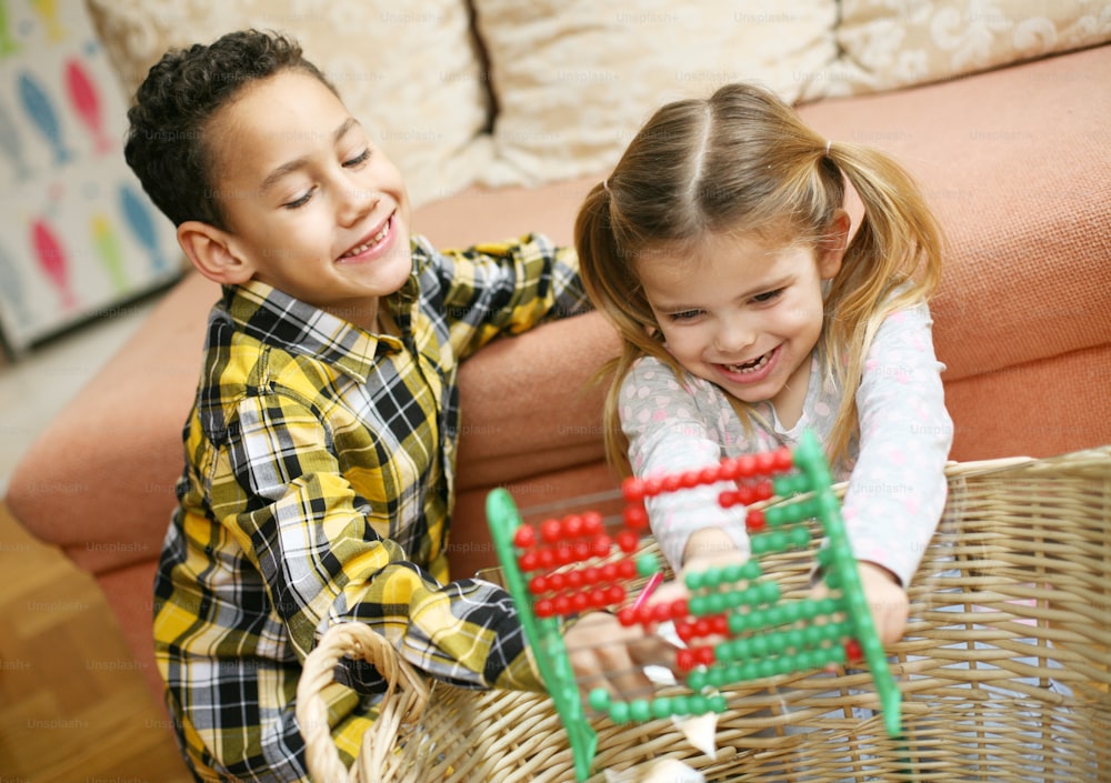 Close up of little girl and little boy accounting. Little children working together homework.