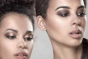 Two beauty young african american women. Closeup portrait of beautiful girls with natural makeup.