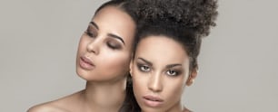 Two beauty young african american women. Closeup portrait of beautiful girls with natural makeup.