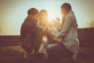 Happy family playing outdoor. Family enjoying together in nature.