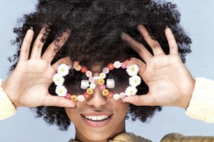 Portrait of happy young african american girl with afro hairstyle and funny sunglasses.