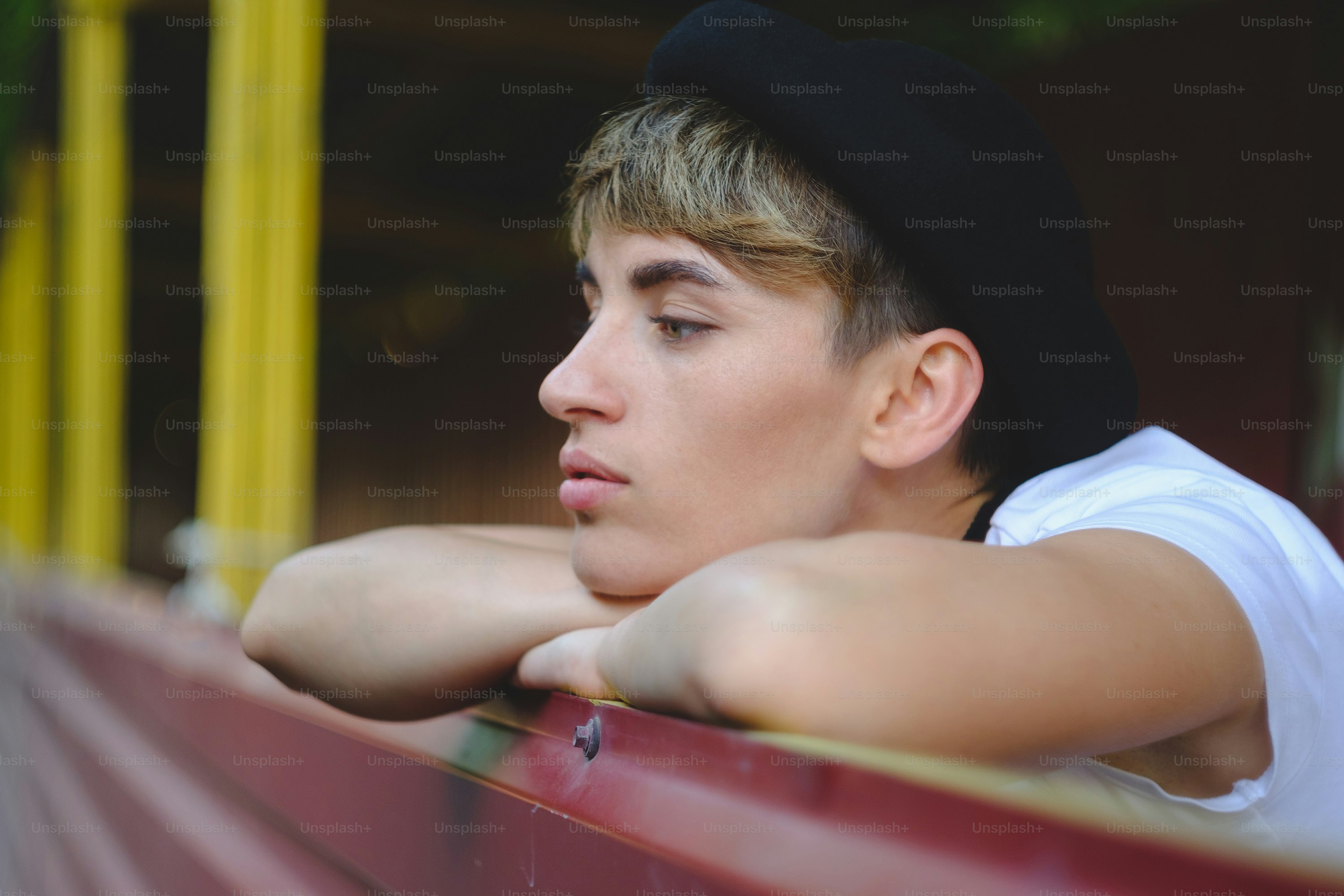 Close up portrait of female hipster with natural makeup and short haircut enjoying leisure time outdoors