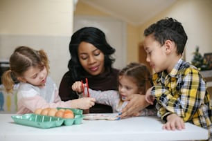 Woman with three child. African American woman with three child prepare for Easter.