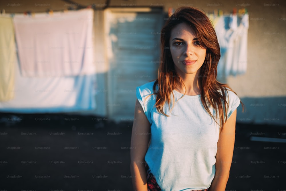Portrait of young beautiful brunette girl in white shirt