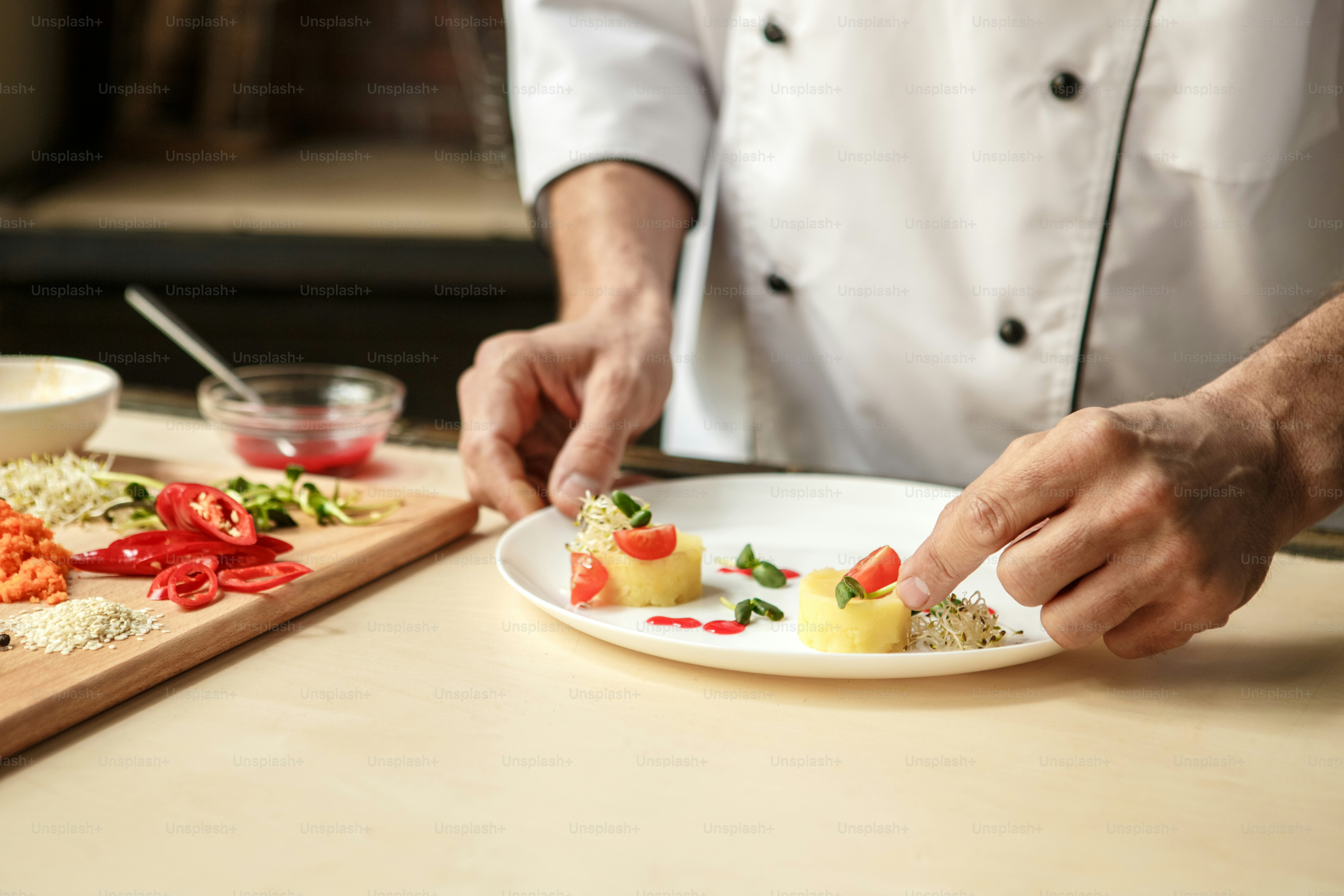 Mature male professional chef cooking meal indoors decorating