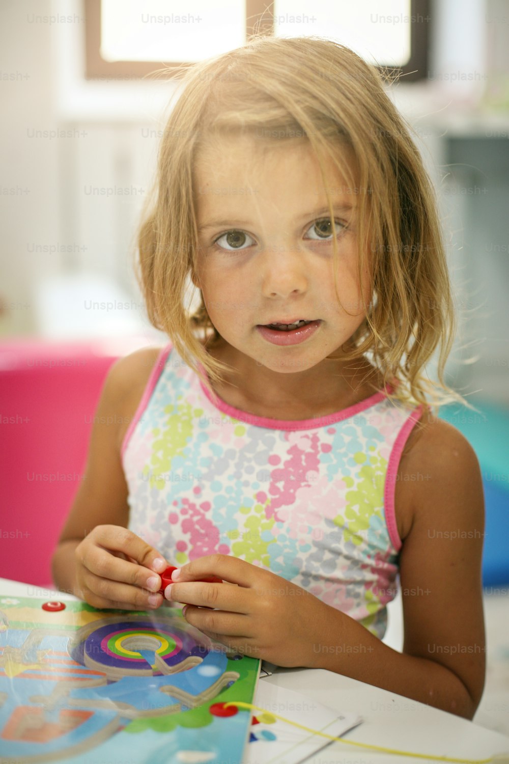 Little girl playing in playground. Girl playing with toys.