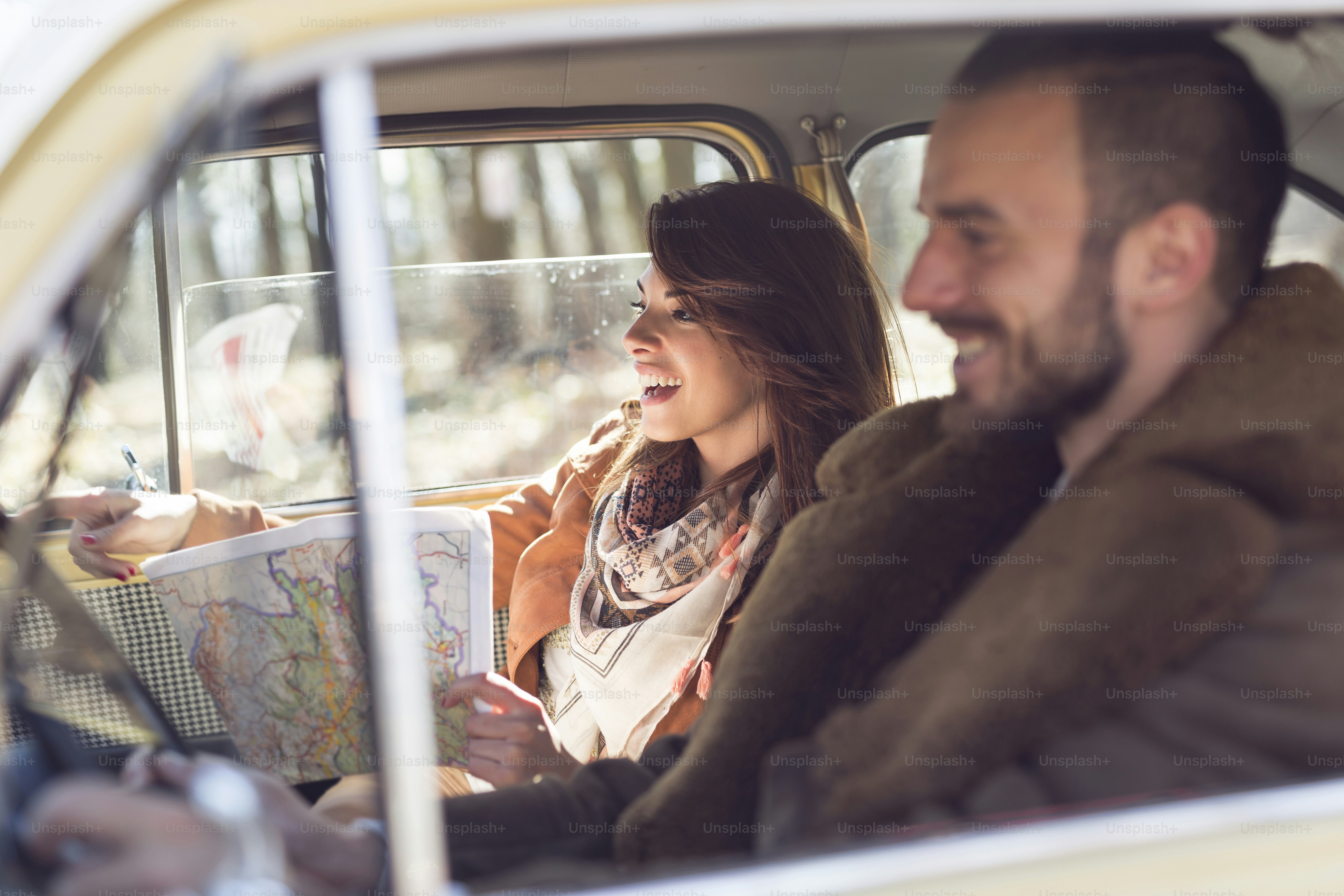 Young couple on a road trip, enjoying the sunny autumn day and having fun