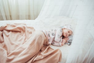 child little girl sleeps in the bed.