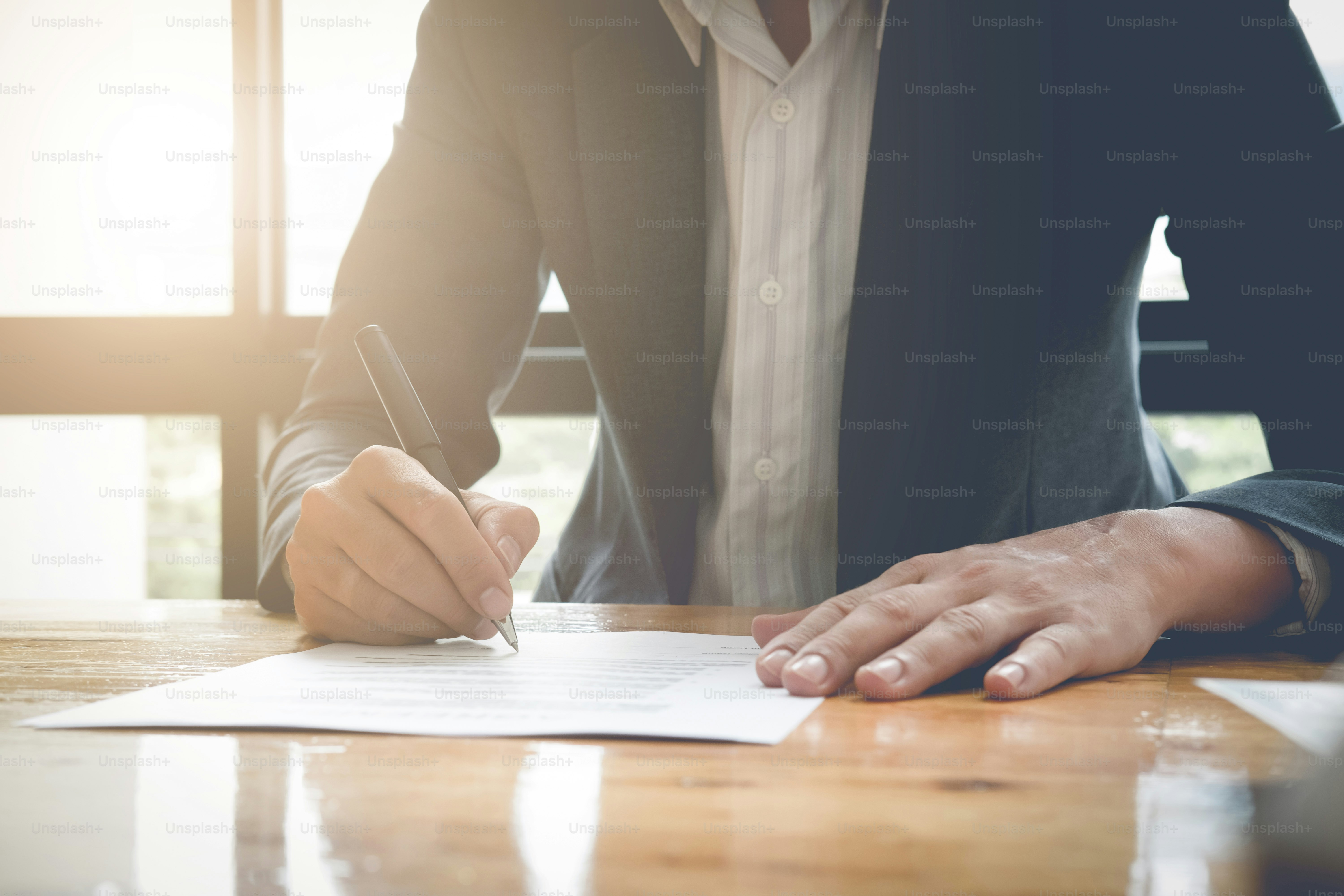 Close-up Of Businessman Signing Contract Paper With Pen, vintage filter effect