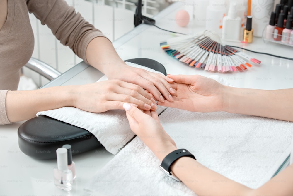 Young female in beauty salon nail care preparation