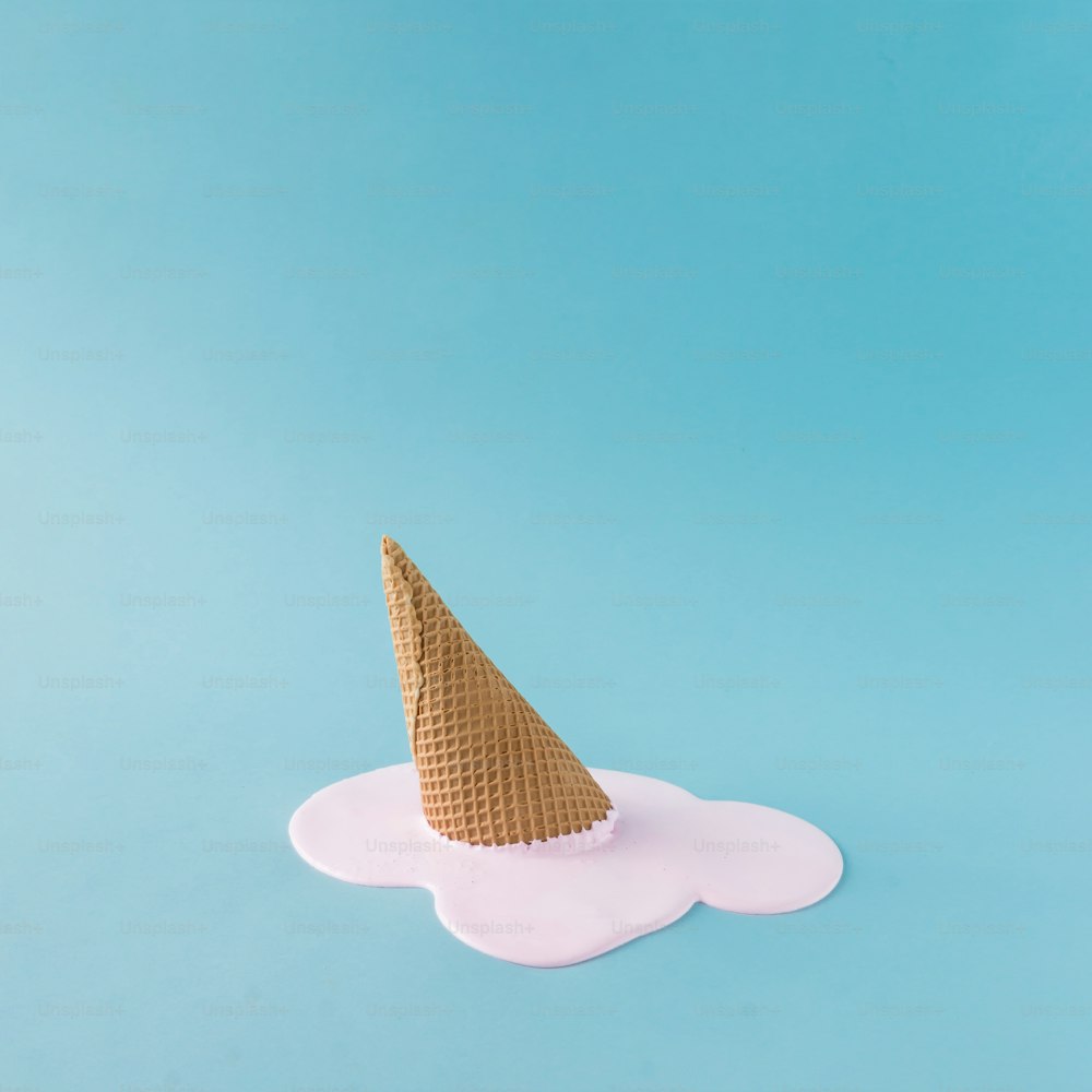 Overhead pink ice cream on pastel blue background. Minimalistic summer food concept.