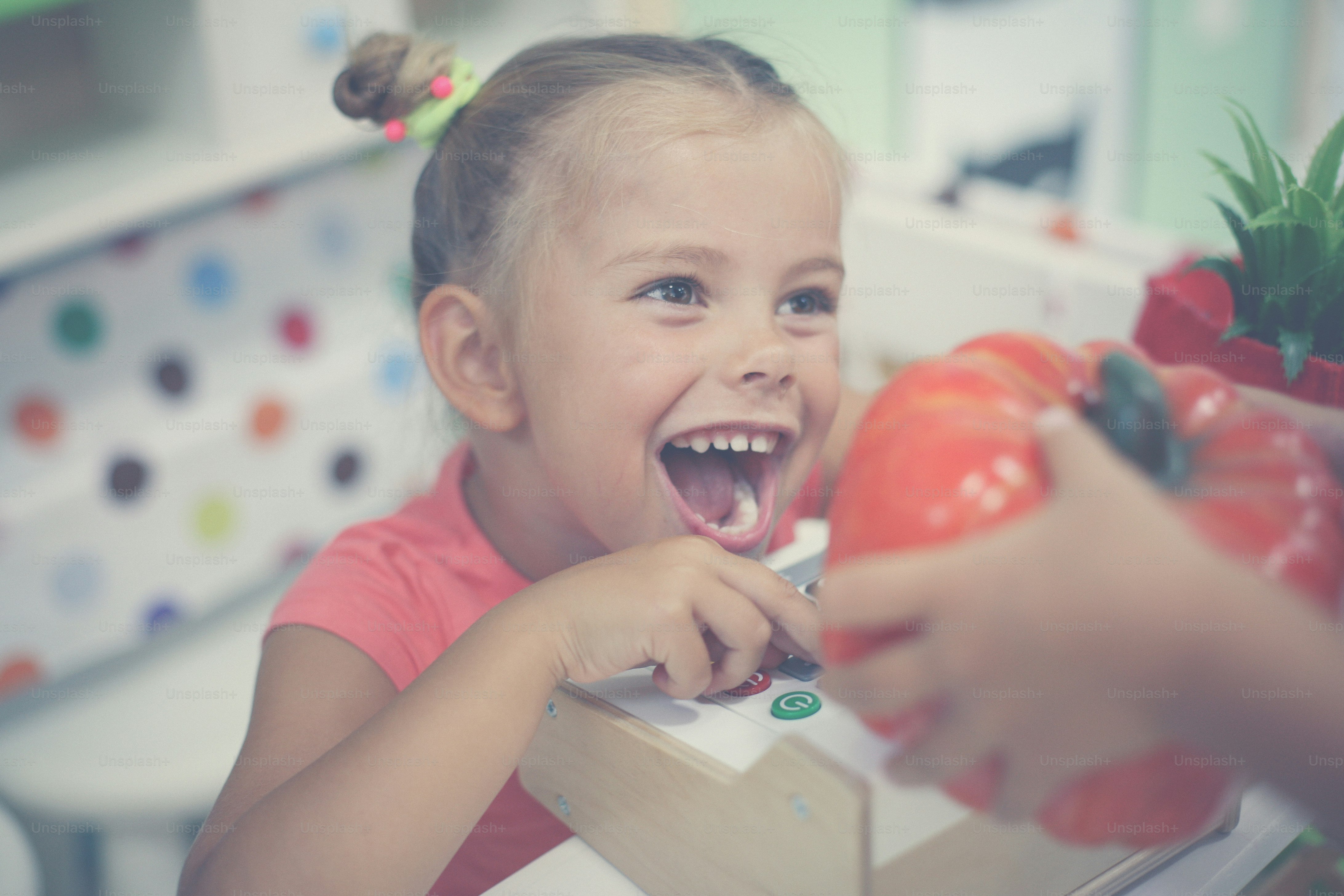 Little girls in playground. Happy girl playing with children cash register.