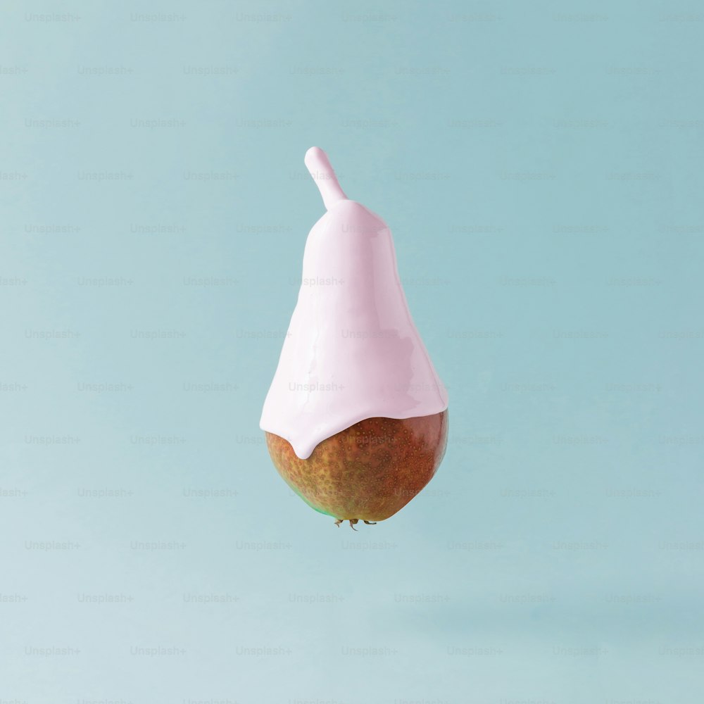 Pear with ice cream topping on pastel blue background. Food creative concept.